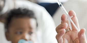 Injection for infant being prepared.