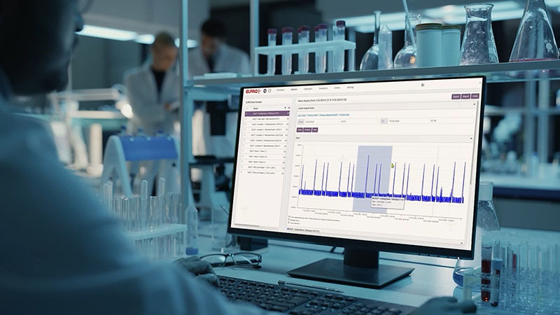 A lab assistant sits in front of the computer and looks at the analysis on the screen