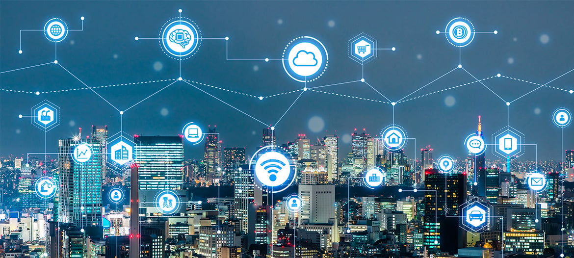 Modern city skyline at night with digital network icons and connected nodes overlay, representing IoT, cloud computing, and smart city technology