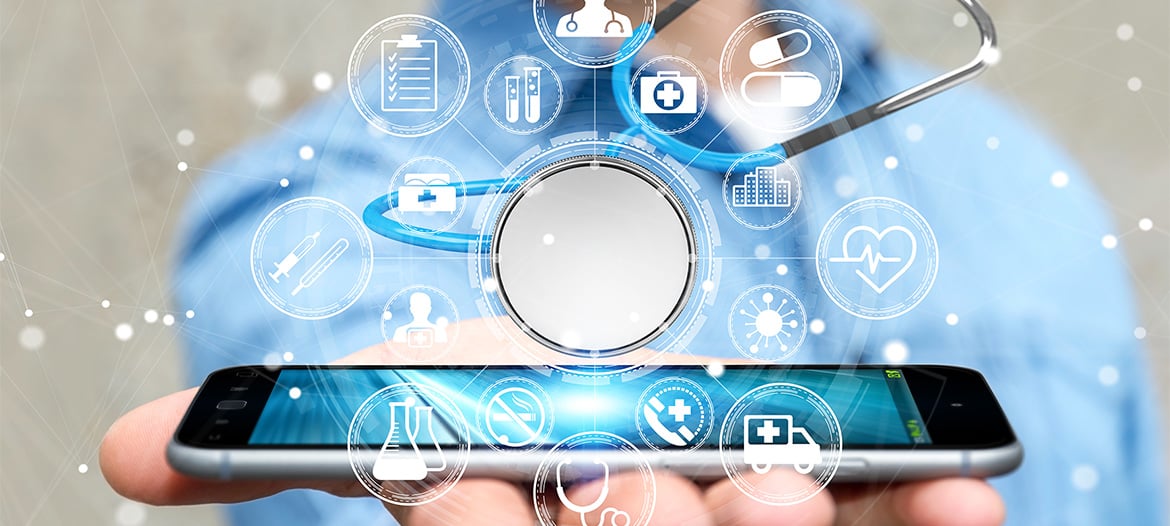A hand holding a smartphone upward, with various icons emerging from the screen representing clinical trial supply topics