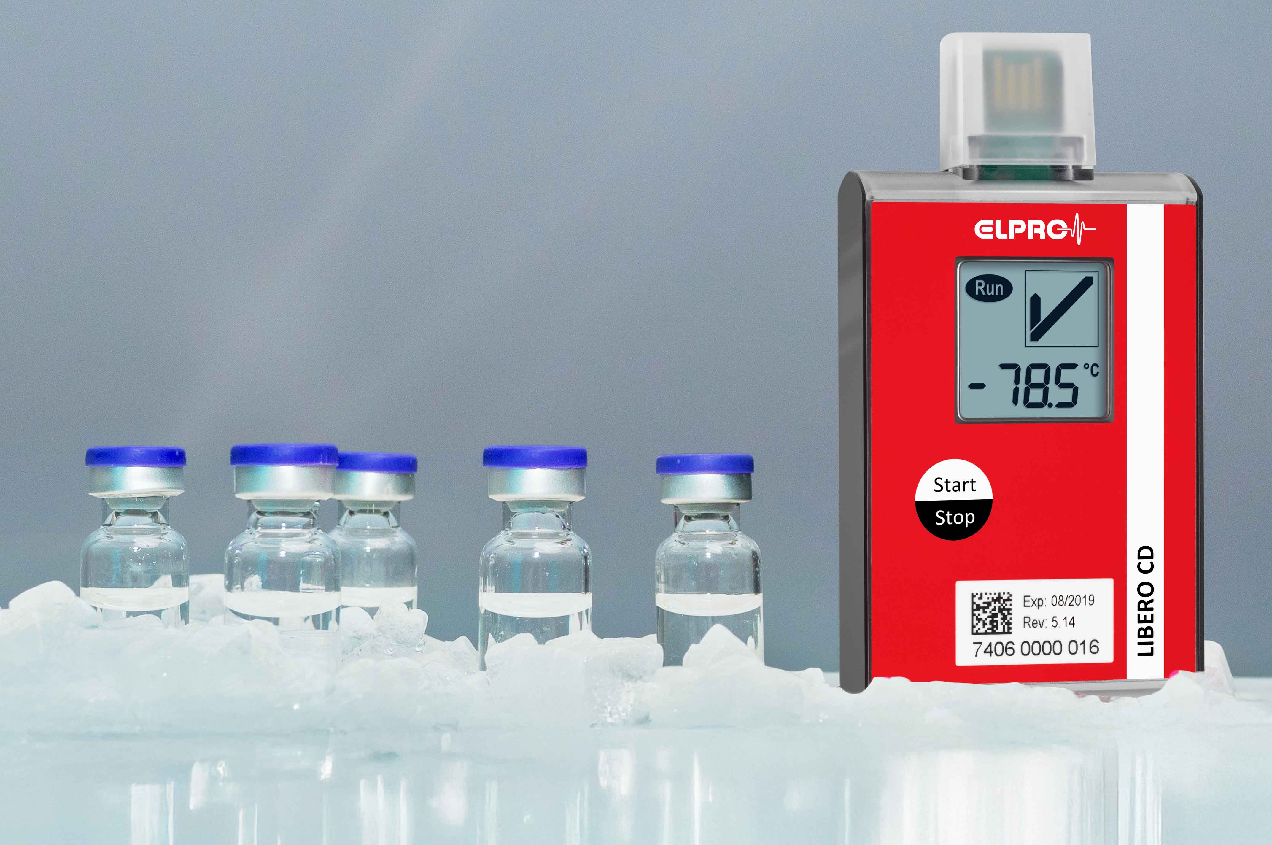 LIBERO CD measuring device stands next to six vaccine vials.