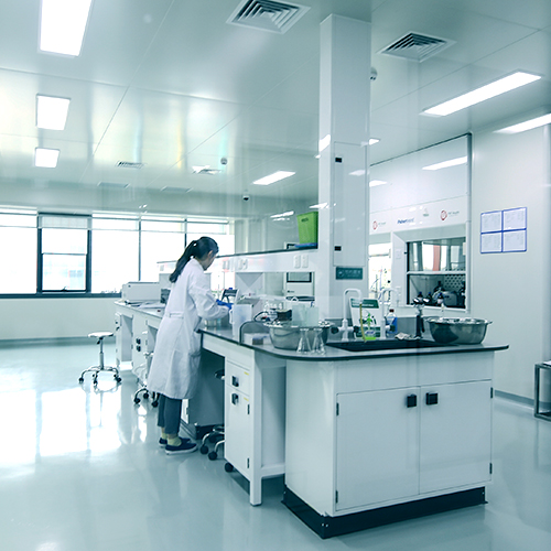 A laboratory technician sorts various containers on the table.
