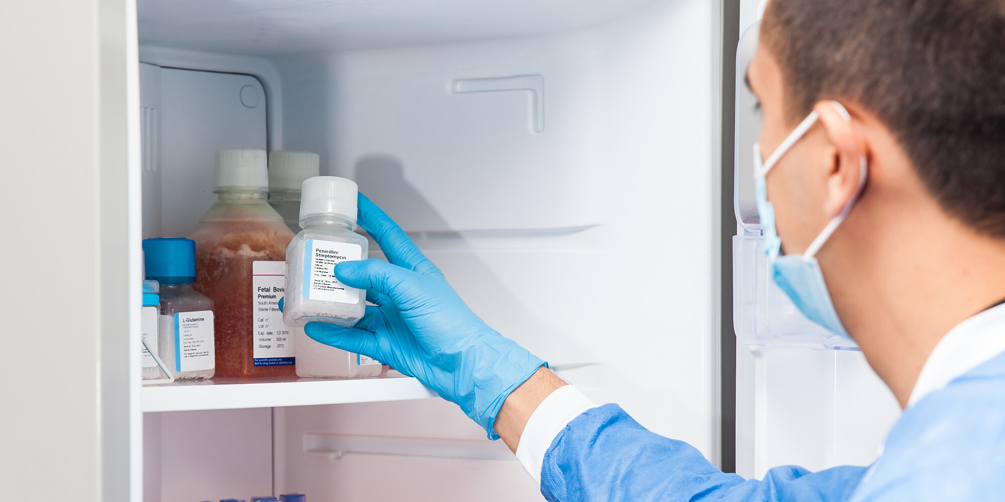 Pharmacist takes vaccine out of fridge.