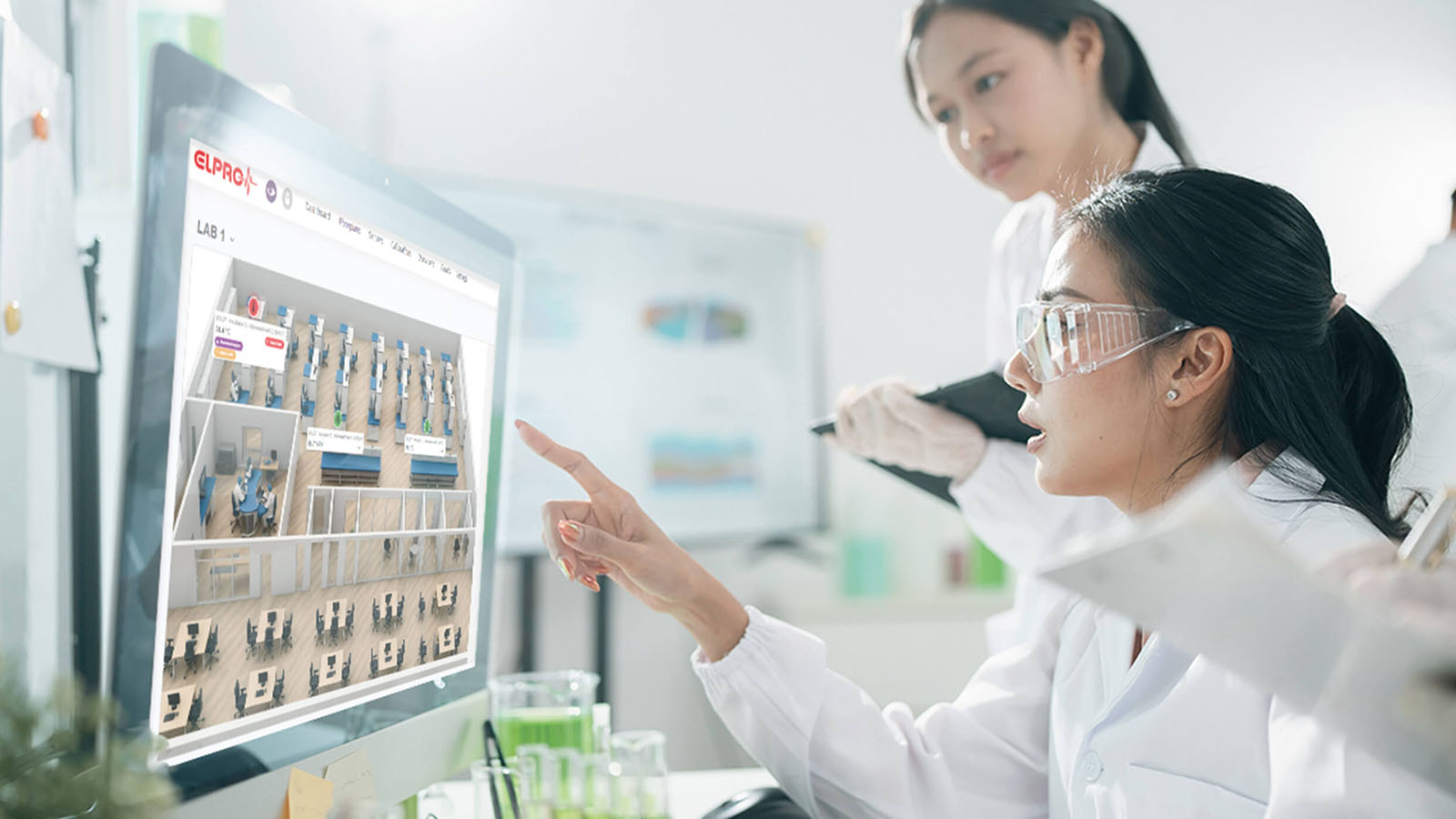 Quality team reviewing monitoring data and dashboards on a computer screen in a laboratory to identify deviations and initiate timely corrective actions.